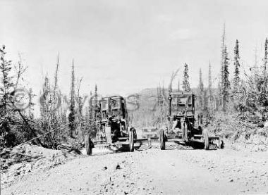 Graders level roadbed during construction