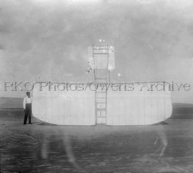 Orville Wright Next to Upended Glider