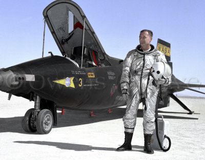 NASA test pilot Milt Thompson stands next to X-15