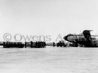 Flag-draped coffins of astronauts carried to Air Force plane