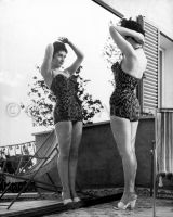 Gina Lollobrigida wearing swimsuit & high heels