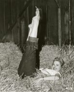 Martha Hyer in barn barefoot