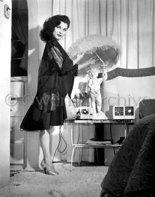 Debra Paget wearing see thru nightgown and high heels