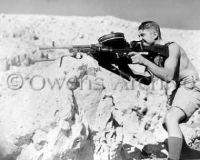 New Zealand soldier firing dual machine-gun 