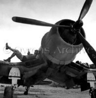 Pilots relaxing on F4U-4 Corsair fighter