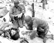 Medics Help Wounded Soldier on Omaha Beach