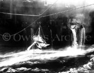 Transfer wounded men off USS Bunker Hill 