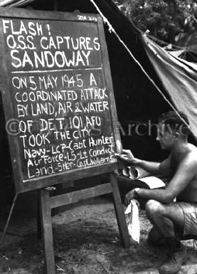 Sign next to Intelligence tent, O.S.S. Captures Sandoway 