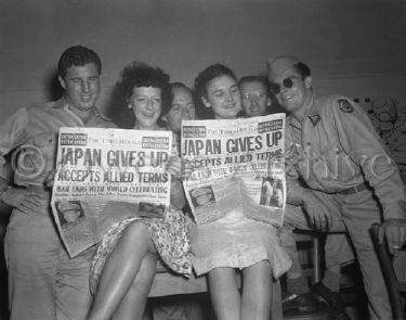 Reading the newspaper on V-J Day