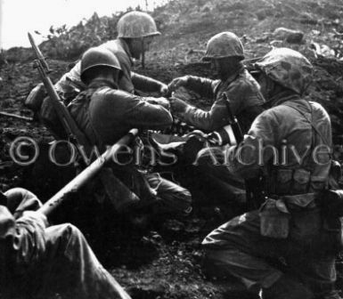 Marines tie American flag to pole, Mount Suribachi