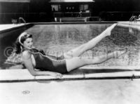 Esther Williams sitting by the pool