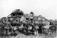 German soldiers standing next to tank