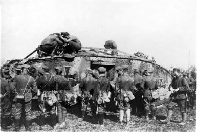 German soldiers standing next to tank